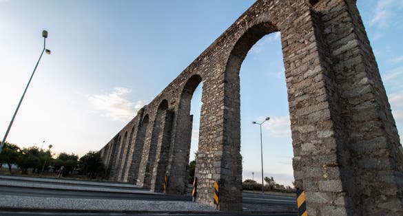 Água de Prata aqueduct on a road  in the city of Evora - Portugal