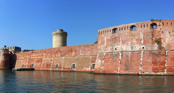 Moated Fortezza Vecchia Castle with its thick waterfront walls in Livorno, Italy