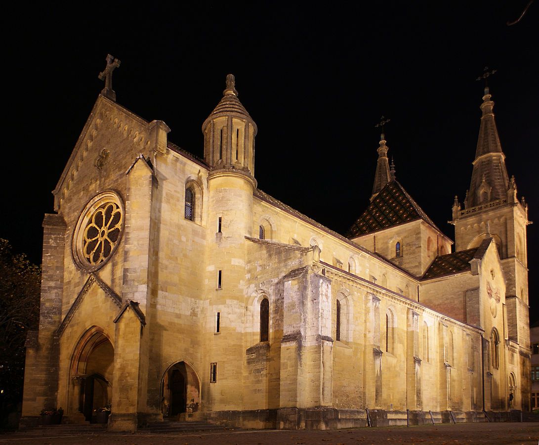 photo of night view of Collégiale de Neuchâtel in Neuchatel, Switzerland.