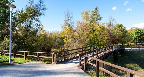Photo of light post and a wooden bridge in Bundek city park, Zagreb, Croatia.