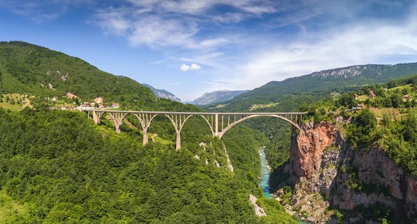 Photo of aerial view of Djurdjevica Tara Bridge is a concrete arch bridge over the Tara River in northern Montenegro. 365m long and the roadway stands 172 metres above the river.