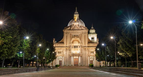Photo of iIluminated facade of the Papal Basilica of Saint Mary of the Angels in Santa Maria degli Angeli, Assisi, region of Umbria, Italy.