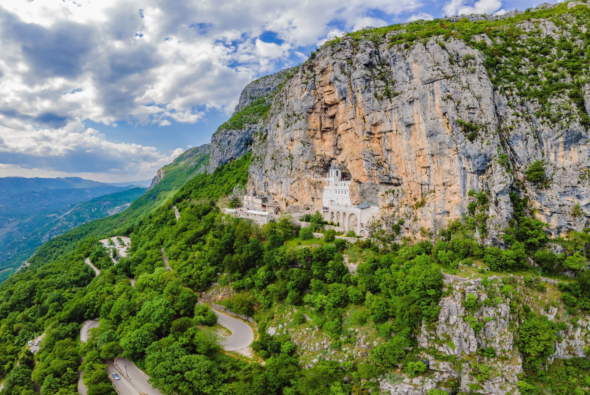 Photo of aerial view of Monastery of Ostrog is a monastery of Serbian Orthodox Church placed against an almost vertical rock of Ostroska Greda, Montenegro.