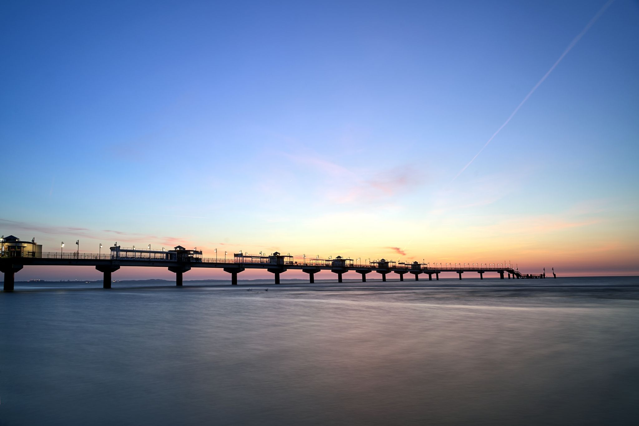 Photo of concrete pier on the Baltic Sea In the evening in Miedzyzdroje, Poland.