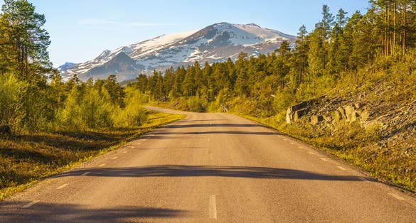 Road to Stora sjöfallet nationalpark in spring time with mountains in background with snow on top, Stora sjöfallet nationalpark, Gällivare county, Swedish Lapland, Sweden