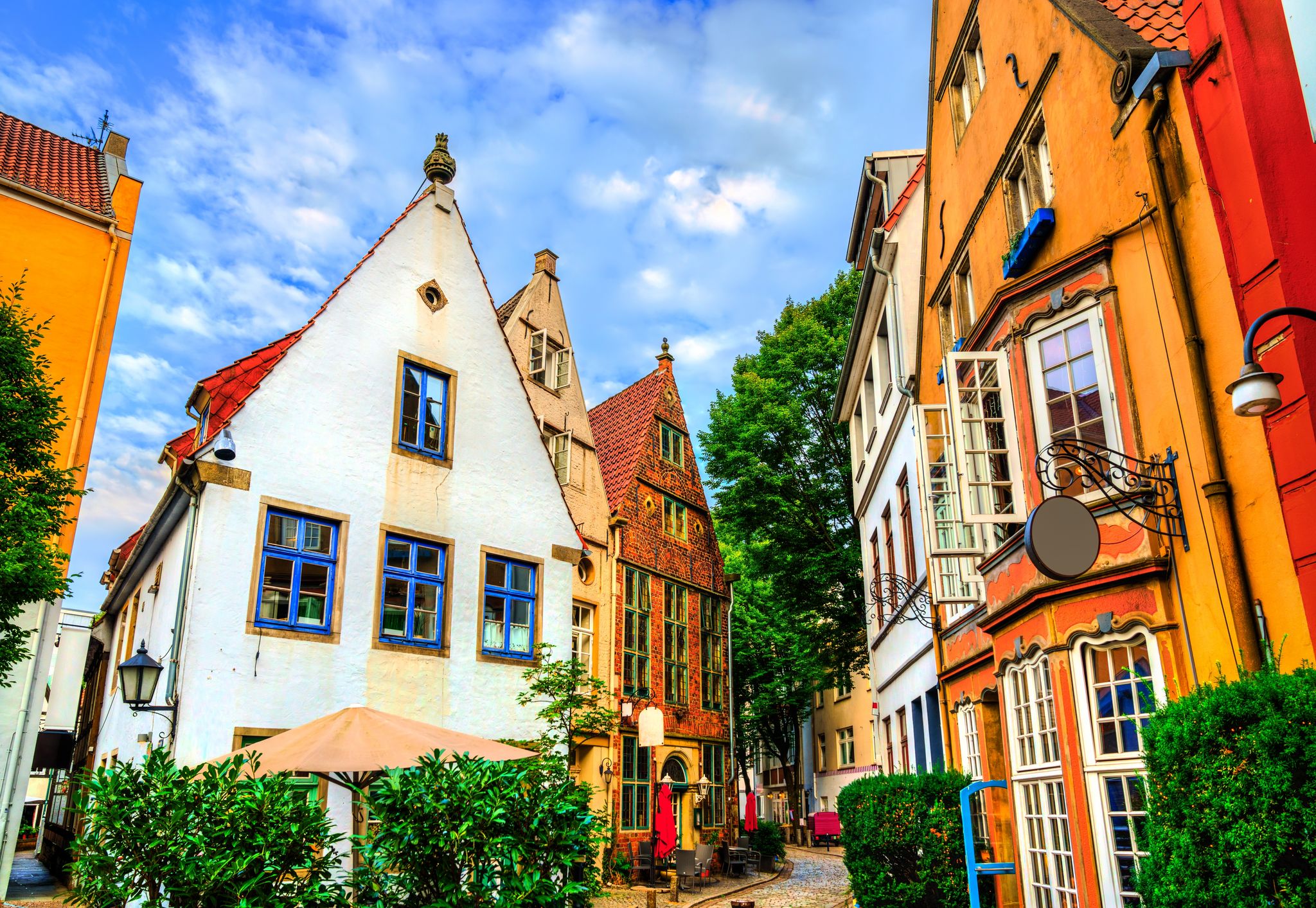 Photo of beautiful panoramic view of historic Bremen Market Square in the center of the Hanseatic City of Bremen with The Schuetting and famous Raths buildings on a sunny day with blue sky in summer, Germany.