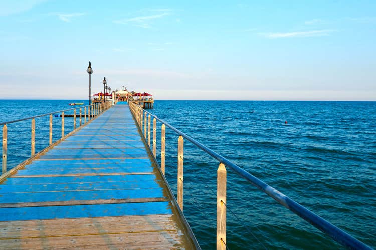 photo of view Wooden pier near of Adriatic sea. Lignano Sabbiadoro, Italy.