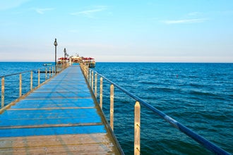 photo of view Wooden pier near of Adriatic sea. Lignano Sabbiadoro, Italy.