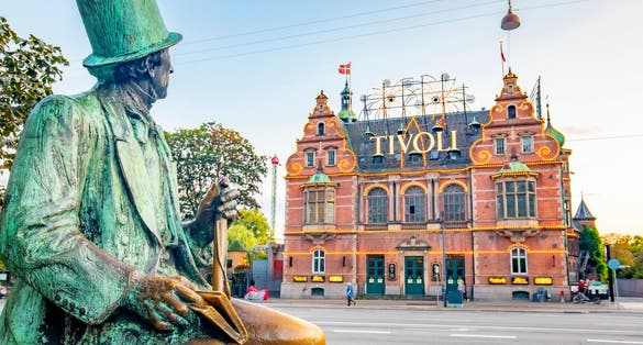 Photo of Hans Christian Andersen sculpture and entrance to Tivoli Garden park, Copenhagen, Denmark.