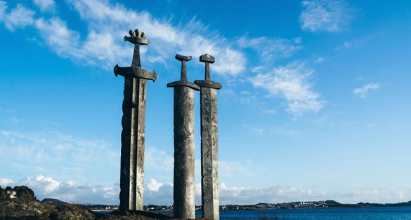 Photo of three large swords Sverd i Fjell stand on the hill as a memory to the Battle of Hafrsfjord in year 872 in Stavanger, Norway.