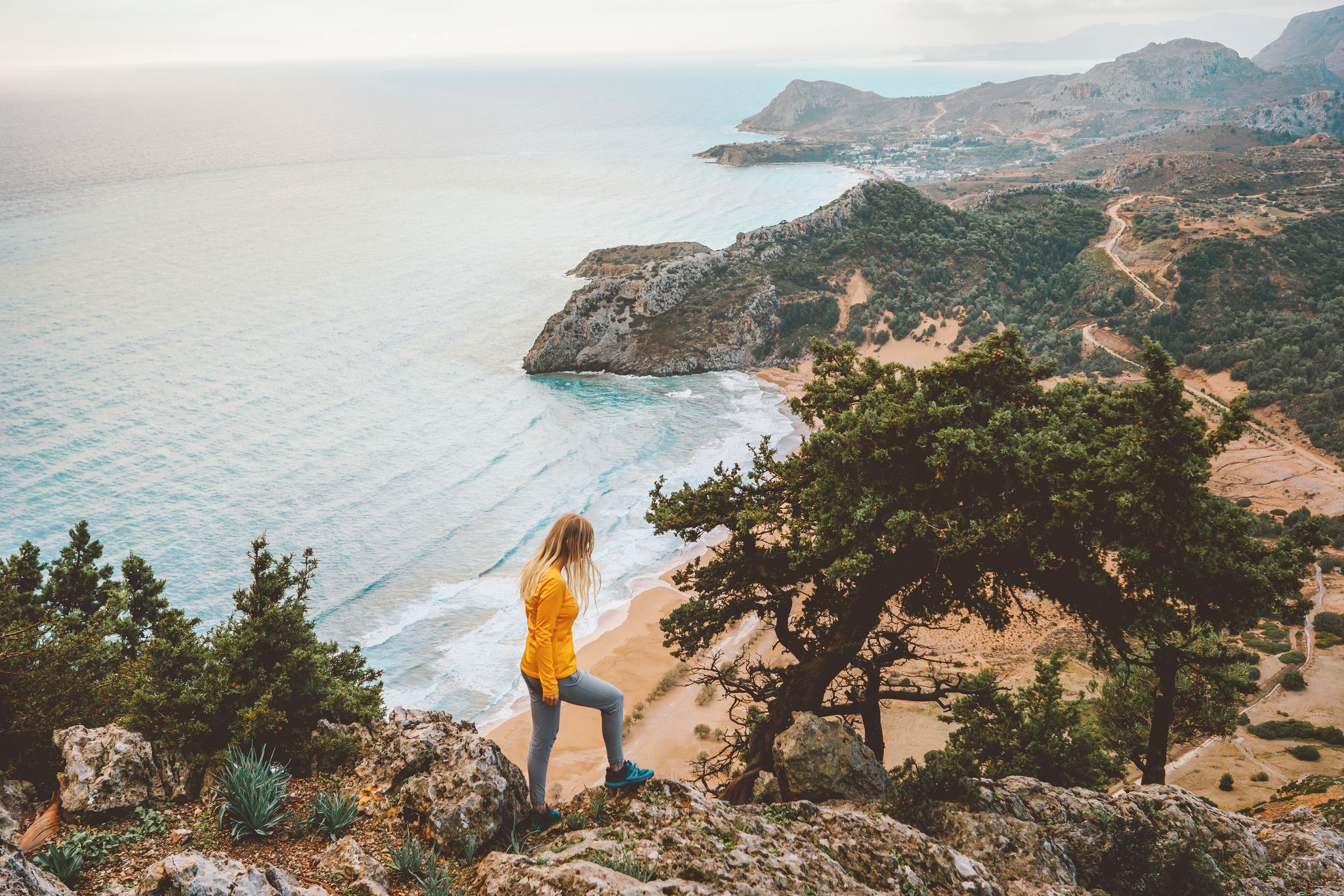 photo of view Greece vacations woman hiking in Rhodes island travel outdoor tourist sightseeing aerial tsambika beach, Tsambik, Greece.a