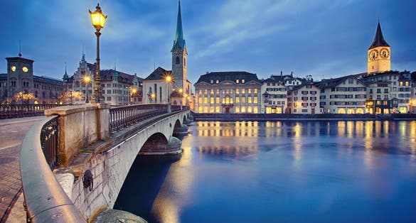 Photo of view on Fraumunster Church and Church of St. Peter at night, Zurich, Switzerland.