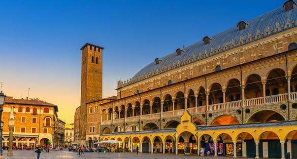 PHOTO OF Palazzo della Ragione medieval town hall and palace of justice building, Torre degli Anziani tower in Piazza dei Frutti square in Padua historical centre, twilight evening view, Veneto Region, Italy