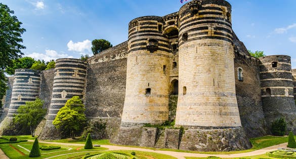 Photo of Angers, France: Castle of Angers, founded in 9th century by the Counts of Anjou, expanded to its current size in 13th century, a historical monument since 1875, located overhanging the river Maine.