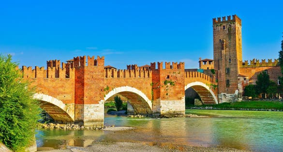 photo of View of the Castel Vecchio Bridge connected to Castelvecchio Castle along Adige river in Verona, Italy. 