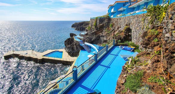 Caniço, Madeira - Outdoors swimming pool on a multi-level terrace among the coastal lava rocks of CaniÃ§o on the southern coast of Madeira island (Portugal) near Funchal