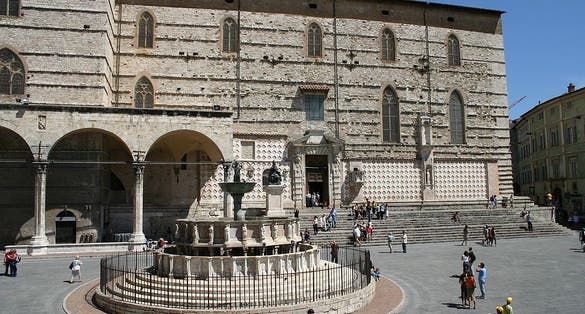 photo of view  of The cathedral's south wall with the Loggia di Braccio on the left and the Fontana Maggiore in the foreground, Perugia, Italy.