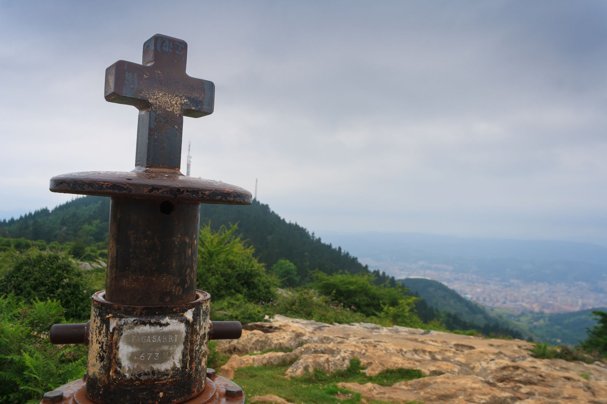 Photo of Metal cross at the top of the Pagasarri mountain, Bilbao, Spain .
