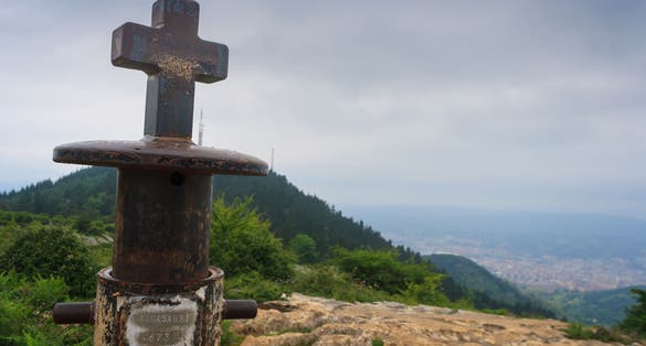 Photo of Metal cross at the top of the Pagasarri mountain, Bilbao, Spain .