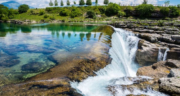 Photo of spectacular waterfall in Podgorica, called Niagara falls of Cijevna river azure waters in untouched green nature scenery, Montenegro.