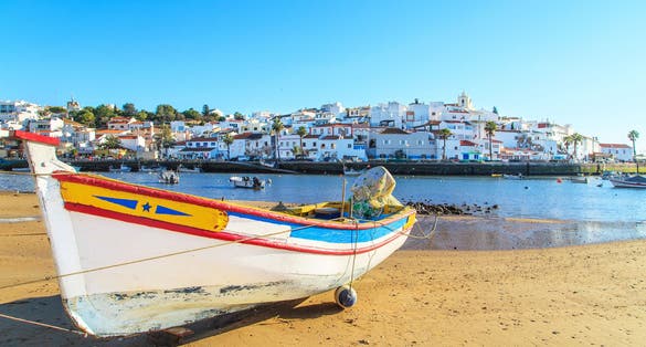 Photo of boat in warm sunset light on the beach in Portimao, Portugal