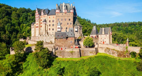 photo of view Eltz Castle or Burg Eltz is a medieval castle in the hills above the Moselle River near Koblenz in Germany.