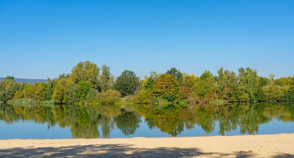 photo of view of Bathing lake with a small sandy beach in the Fuldaaue of Kassel, Germany,Kassel Germany.