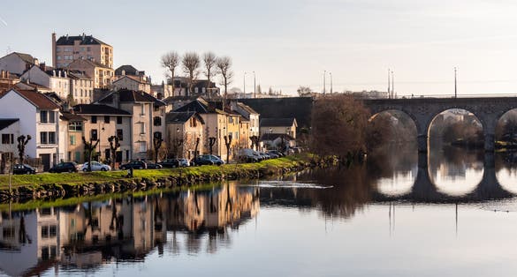 photo of view of View on the quays of Limoges, France. Photographed in autumn and in the evening. View of a bridge and the Vienne River. Reflection on the water.