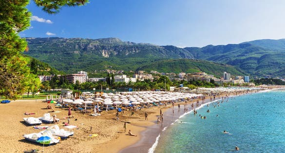 Photo of beautiful beach of Budva with sunbeds and umbrellas, Montenegro.