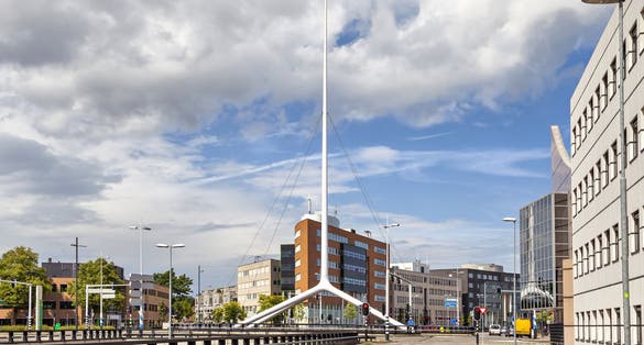 Thin white steeple on one of the crossroads of Eindhoven, Netherlands