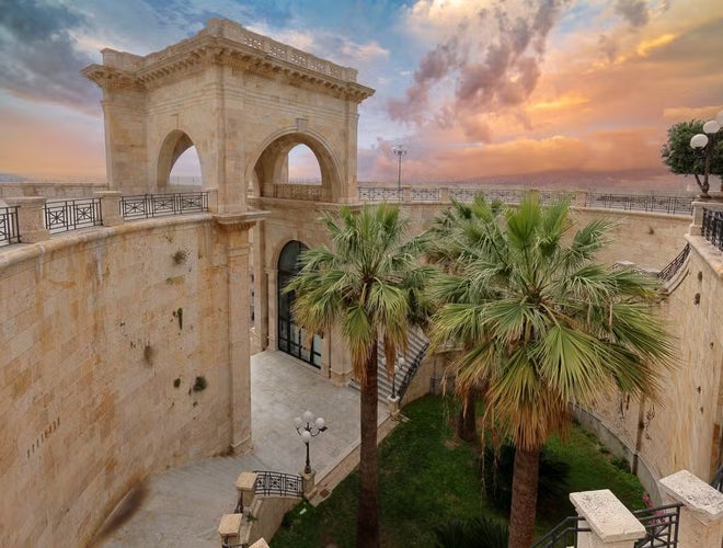 The Bastione Saint Remy in Cagliari, Italy, with its grand arches and historic stone structure under a clear sky..jpg