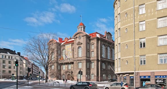 Photo of people walk in front of Museum of Natural History in the center of the city, Helsinki, Finland.