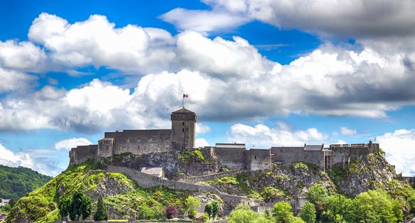 Photo of Chateau Fort on a cloudy sky background. Lourdes, Pyrenees, France.