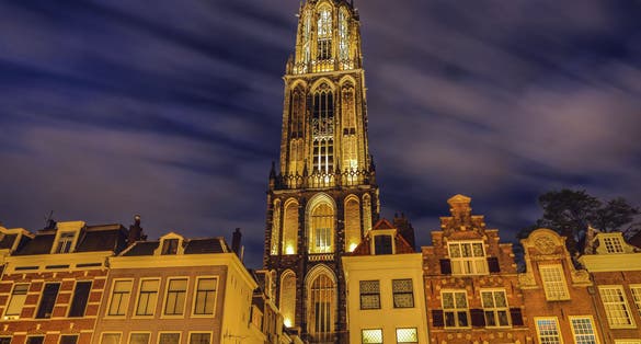 photo of Dom Tower of Utrecht at night in the Netherlands.