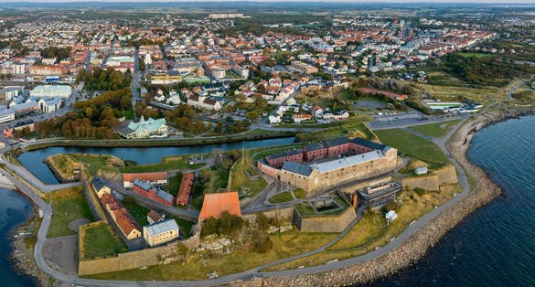 photo of Varberg city seen from above with in the foreground Varberg fortress, a historic defense facility that was originally built at the end of the 13th century.