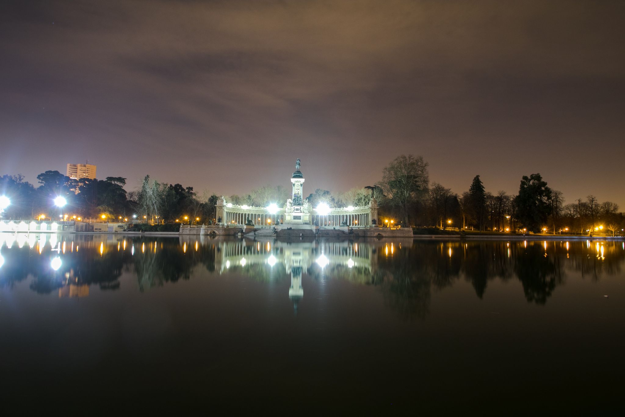 photo of Monument to Alfonso XII in the Parque del Buen Retiro at night in Madrid, Spain.