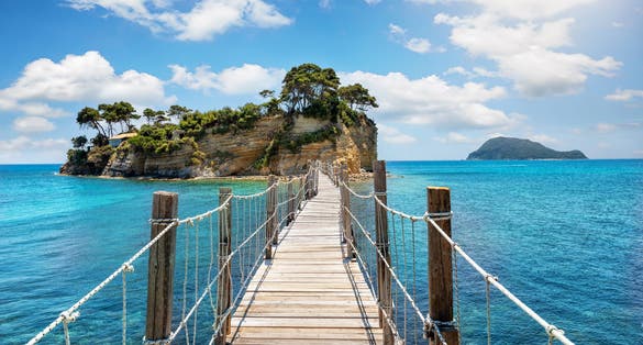 Photo of the wooden footbridge leading to the small island of Agios Sostis on Zakynthos, Greece.