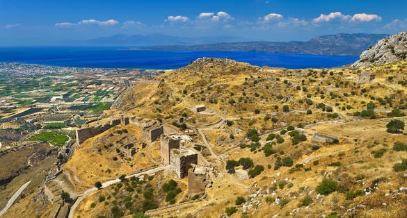 photo of Aerial view of Acrocorinth (the acropolis of ancient Corinth). There is the Corinthian Gulf in the background. Corinth, Greece.