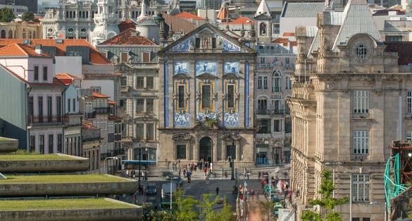 View of the Almeida Garret Square with the Sao Bento railway station and Congregados Church at the back timelapse, Porto, Portugal.