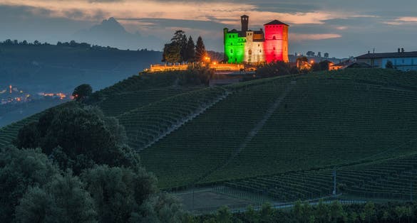 The beautiful Grinzane Castle illuminated in the evening. Langhe region of Piedmont, Cuneo, northern Italy.