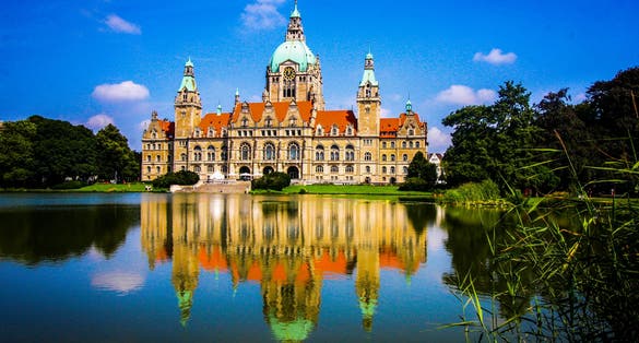 photo of view of New City Hall of Hannover reflecting in water , Lower Saxony, Germany .