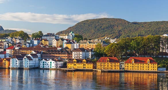 Colorful houses at the waterfront in Bergen, Norway, with reflection in the water, peninsula Nordnes in morning light