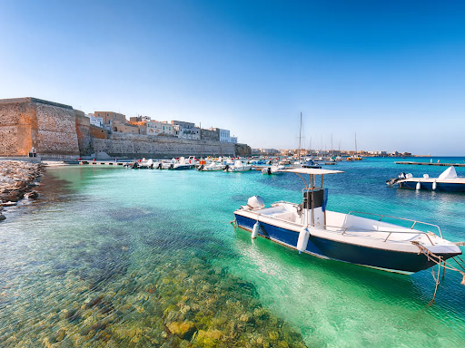 Calm waters and boats in the harbor of Gallipoli, a beautiful seaside town in Italy’s Salento region..png