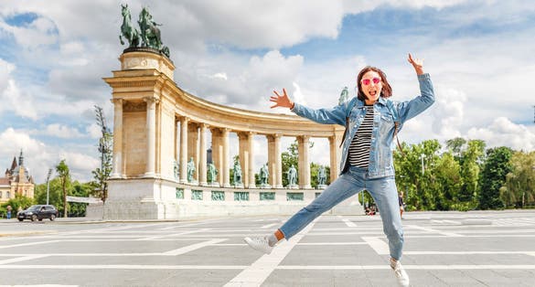 An Asian woman tourist on one of the main attractions of Budapest - Heroes Square. 