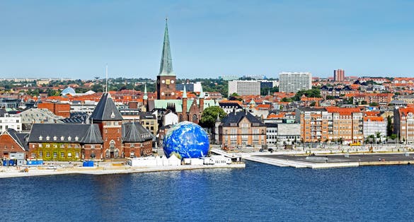 Photo of aerial view of waterfront with Aarhus cathedral and historical building Toldboden, Denmark.