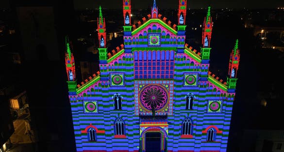 Aerial view of facade of the ancient Duomo in Monza (Monza Cathedral). Drone photography of the main square with church in Monza in north Italy, Brianza, Lombardia. Lights and video mapping.