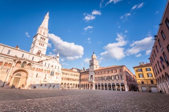 Modena, Emilia Romagna, Piazza Grande illuminated at sunset, with Cathedral Duomo and Ghirlandina Leaning Tower