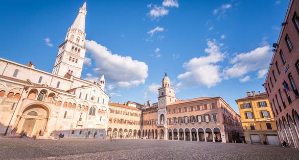 Modena, Emilia Romagna, Piazza Grande illuminated at sunset, with Cathedral Duomo and Ghirlandina Leaning Tower