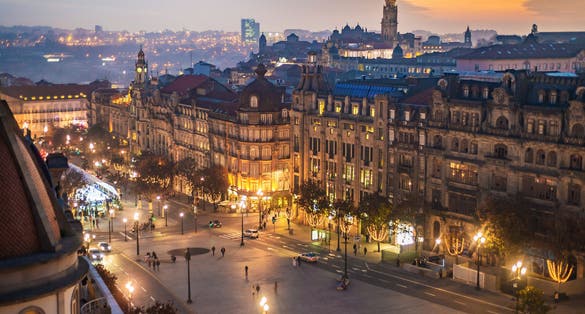 Photo of Aerial view of Aliados / Liberdade Square and Clerigos Tower town of Porto. Sunset view with winter Christmas tree, Portugal.