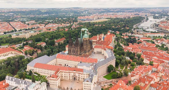 Photo of aerial view of Prague Old Town with St. Vitus Cathedral and Prague castle complex with buildings revealing architecture from Roman style to Gothic 20th century, Czech.